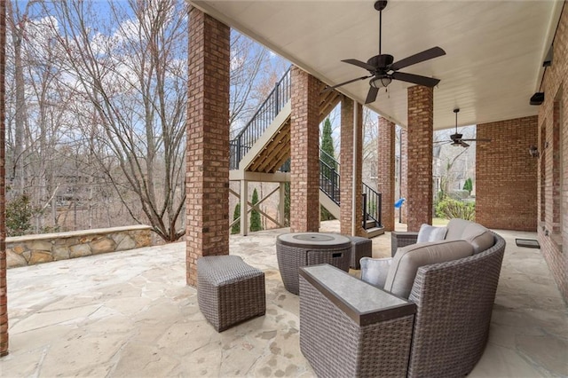 back of property featuring stairs, a chimney, brick siding, and a patio area