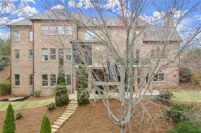 exterior space with stairs and a chimney