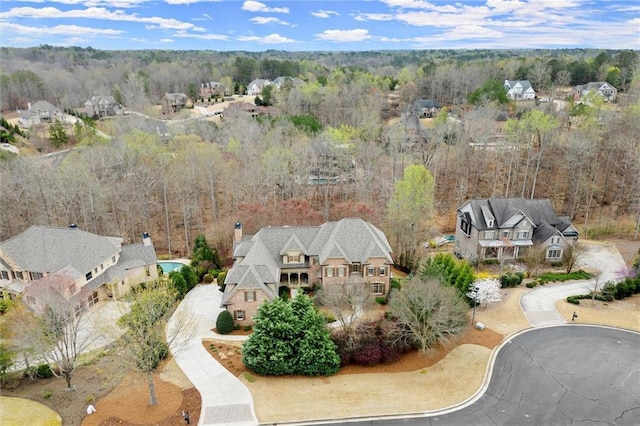 birds eye view of property featuring a view of trees