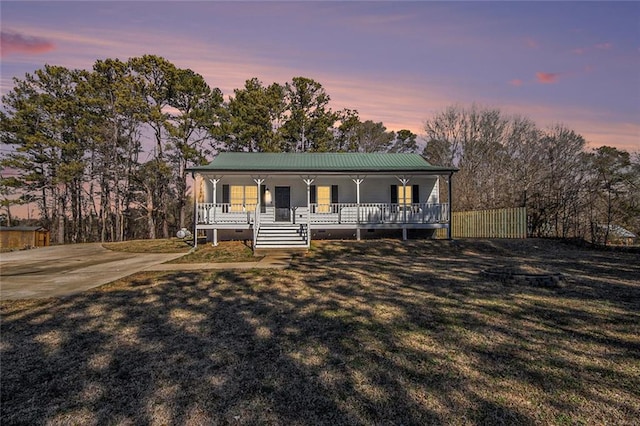 view of front facade with a porch and a yard