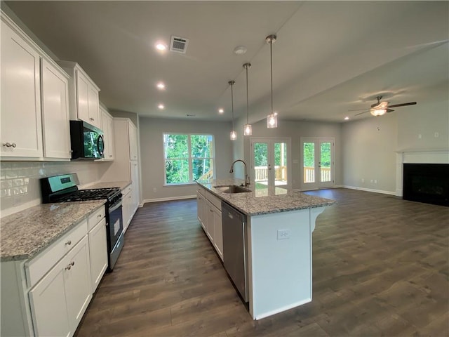 kitchen featuring appliances with stainless steel finishes, a sink, recessed lighting, french doors, and plenty of natural light