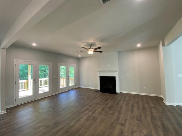 unfurnished living room with french doors, a ceiling fan, dark wood finished floors, baseboards, and a fireplace with flush hearth