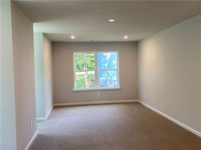 spare room with carpet floors, baseboards, and recessed lighting
