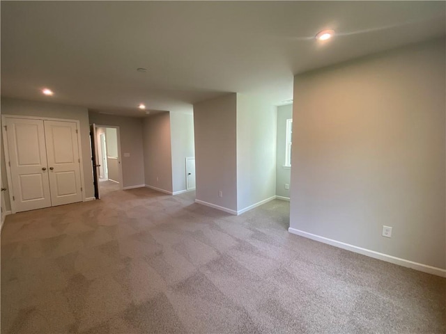 spare room featuring recessed lighting, carpet flooring, and baseboards