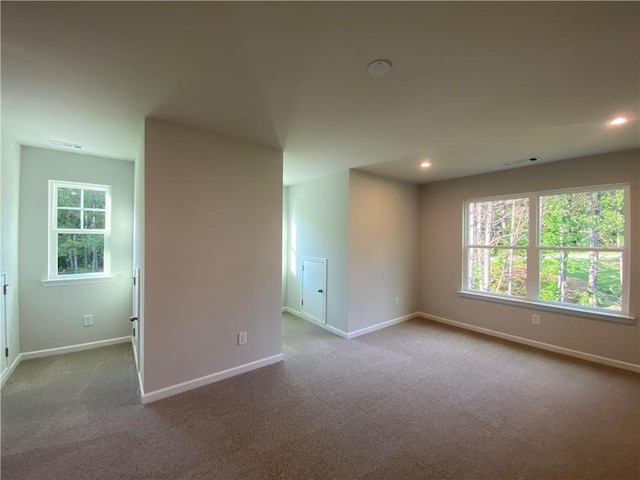unfurnished room with carpet flooring, baseboards, plenty of natural light, and recessed lighting