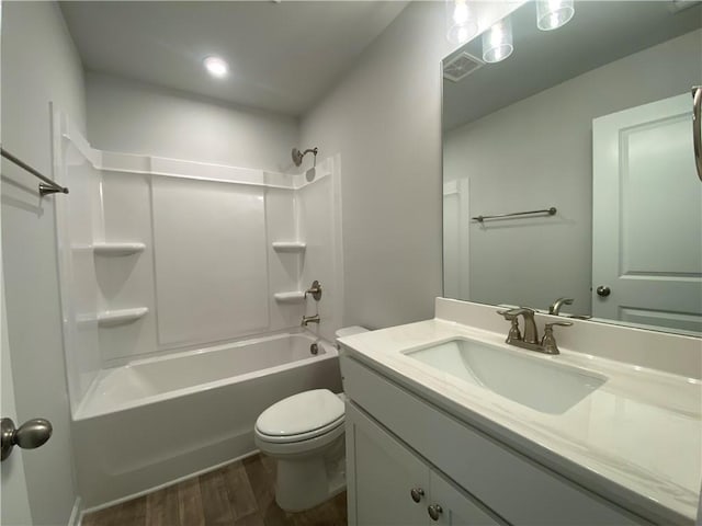full bathroom with wood finished floors, toilet, vanity, and bathing tub / shower combination
