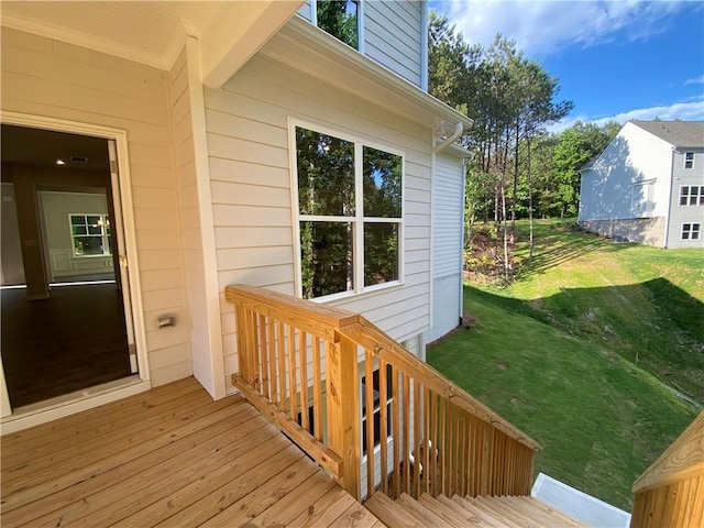 doorway to property with a lawn and a deck