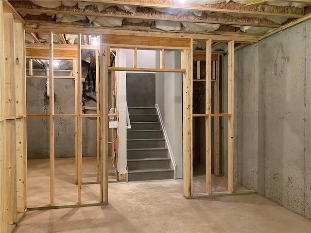 unfinished basement featuring stairway