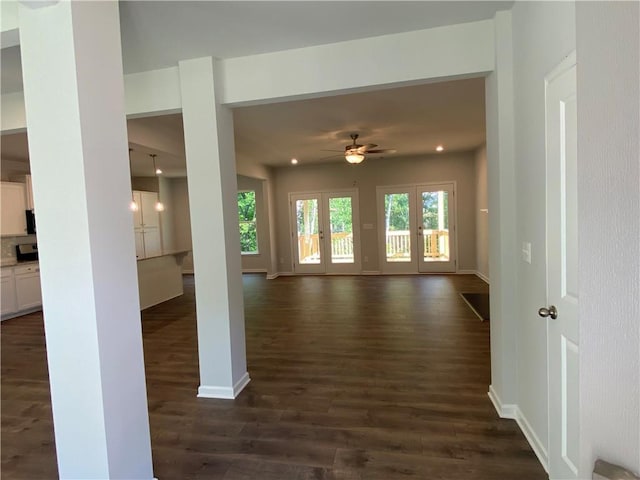spare room with healthy amount of natural light, ceiling fan, dark wood-type flooring, and recessed lighting