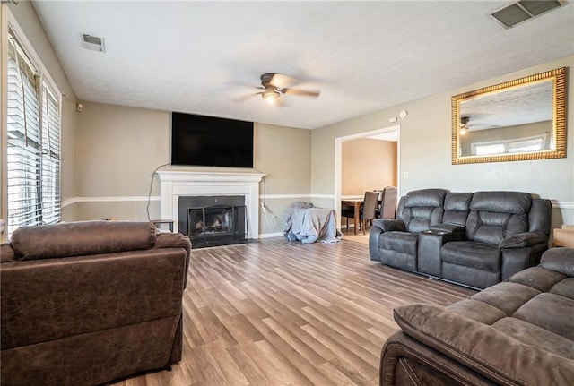 living room featuring ceiling fan and light hardwood / wood-style floors