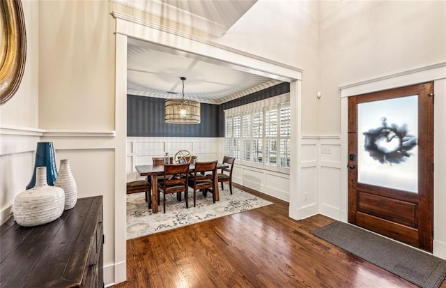 foyer with an inviting chandelier and wood-type flooring