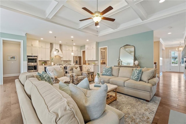 living room with coffered ceiling, ceiling fan with notable chandelier, beamed ceiling, and light wood-type flooring