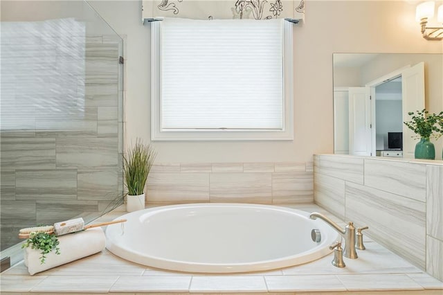 bathroom featuring independent shower and bath