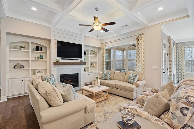 living room featuring coffered ceiling, built in shelves, dark hardwood / wood-style flooring, and beam ceiling