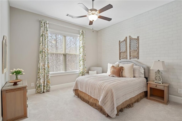 carpeted bedroom featuring ceiling fan and brick wall