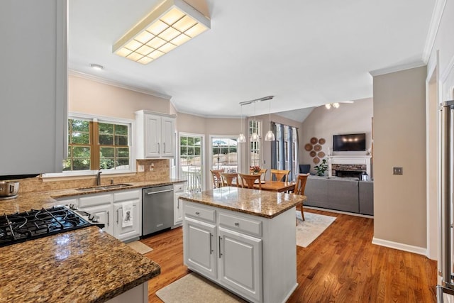 120 Ashewoode Downs Ln, Alpharetta, GA 30005 - kitchen with stainless steel dishwasher, a kitchen island, ornamental molding, white cabinets, and light wood-style floors