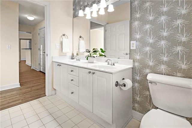 bathroom featuring tile patterned flooring, a sink, and toilet