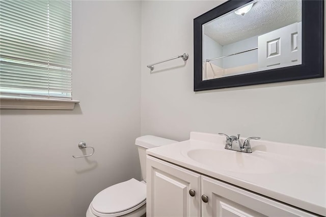 full bathroom featuring vanity, a textured ceiling, and toilet