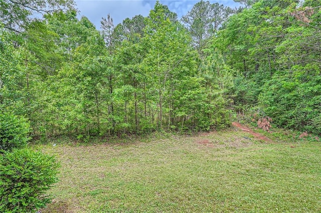 view of yard with a view of trees
