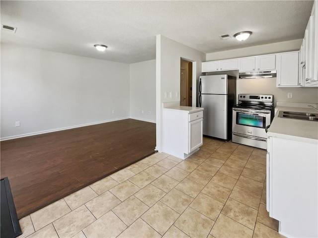 kitchen with white cabinetry, stainless steel appliances, sink, and light tile patterned floors