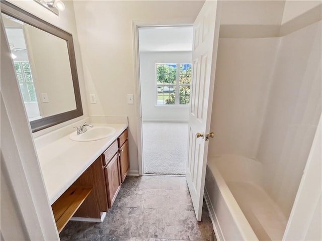 bathroom featuring walk in shower and vanity