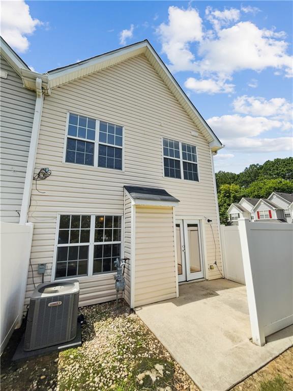 back of property with a patio area and central air condition unit