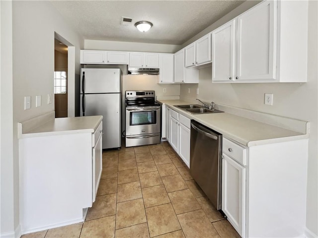 kitchen featuring sink, white cabinets, stainless steel appliances, and light tile patterned floors