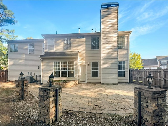 back of property with a patio and central air condition unit