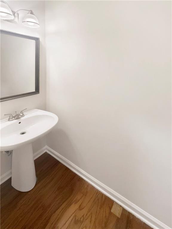 bathroom with hardwood / wood-style flooring and sink