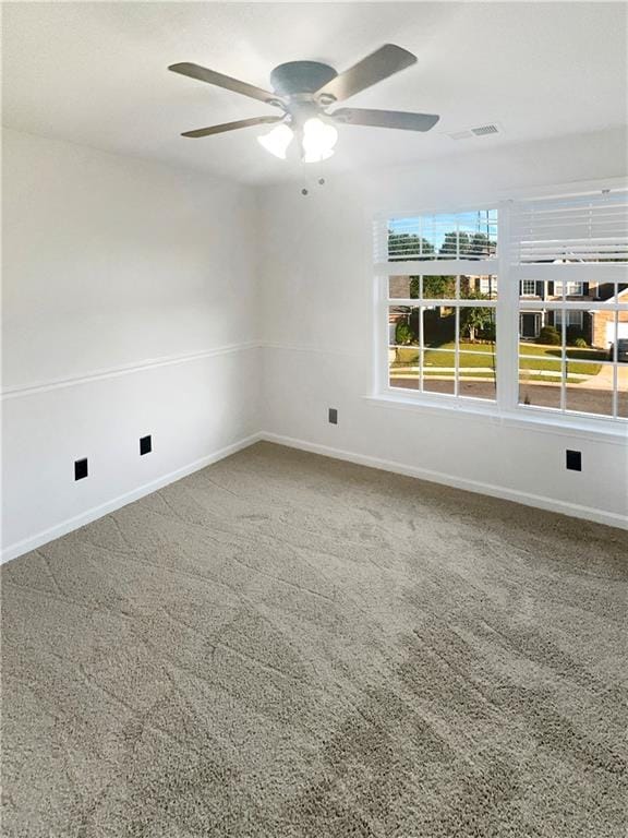 carpeted empty room featuring ceiling fan