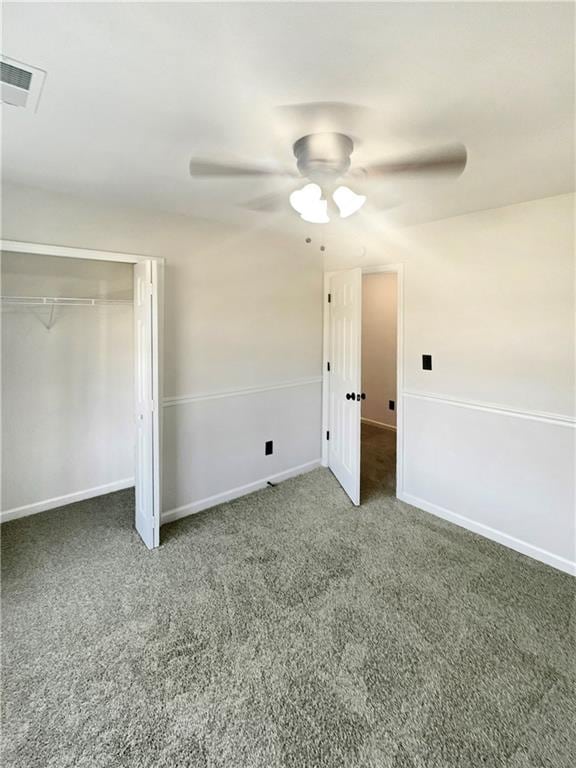 unfurnished bedroom featuring a closet, carpet, and ceiling fan