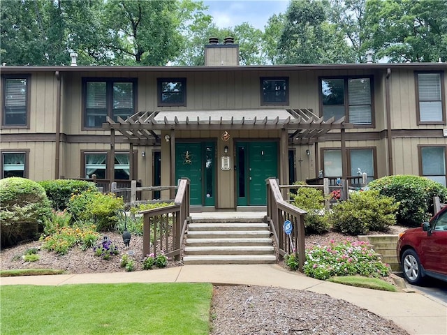 3906 Cedar Cir Unit 3906, Tucker, GA 30084 - view of front of home featuring a pergola, a chimney, and board and batten siding