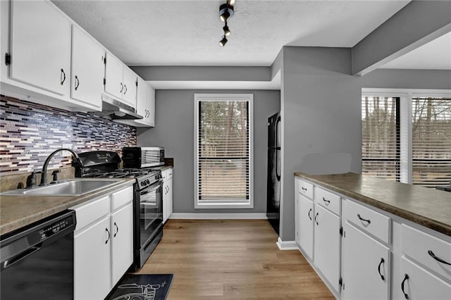 3906 Cedar Cir Unit 3906, Tucker, GA 30084 - kitchen featuring black appliances, tasteful backsplash, white cabinets, light wood finished floors, and under cabinet range hood