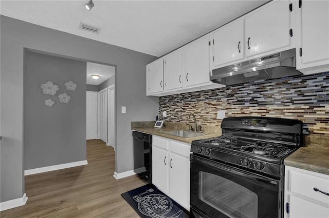 3906 Cedar Cir Unit 3906, Tucker, GA 30084 - kitchen featuring black appliances, under cabinet range hood, white cabinets, light wood-type flooring, and tasteful backsplash