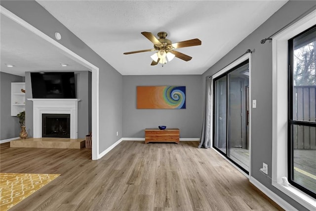 3906 Cedar Cir Unit 3906, Tucker, GA 30084 - unfurnished living room featuring a ceiling fan, wood finished floors, and a tile fireplace