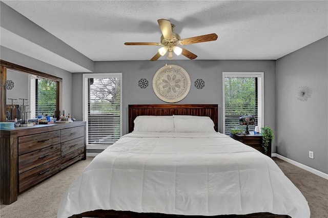 3906 Cedar Cir Unit 3906, Tucker, GA 30084 - bedroom featuring light colored carpet, multiple windows, a textured ceiling, and ceiling fan