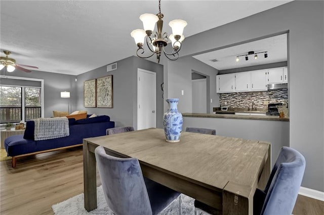 3906 Cedar Cir Unit 3906, Tucker, GA 30084 - dining room featuring wood finished floors, a chandelier, a ceiling fan, and a textured ceiling
