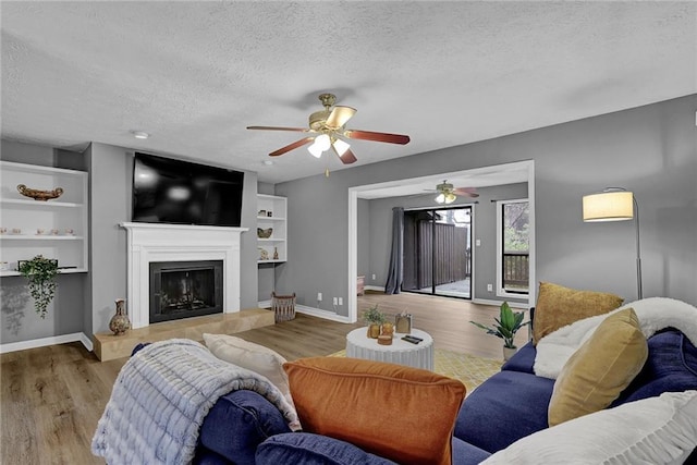 3906 Cedar Cir Unit 3906, Tucker, GA 30084 - living room featuring a textured ceiling, wood finished floors, ceiling fan, and a tile fireplace