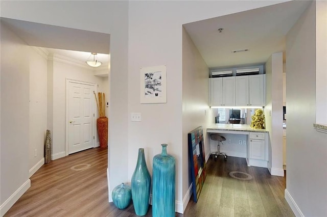 3275 Lenox Rd NE Unit 413, Atlanta, GA 30324 - corridor with wood finished floors, a desk, and crown molding