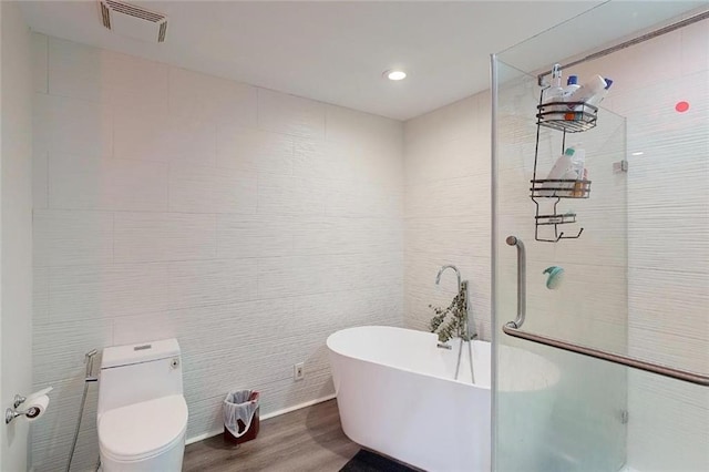 3275 Lenox Rd NE Unit 413, Atlanta, GA 30324 - bathroom with wood finished floors, a soaking tub, tiled shower, and recessed lighting