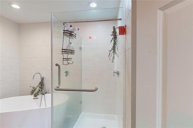 3275 Lenox Rd NE Unit 413, Atlanta, GA 30324 - bathroom featuring a shower stall, a soaking tub, and recessed lighting