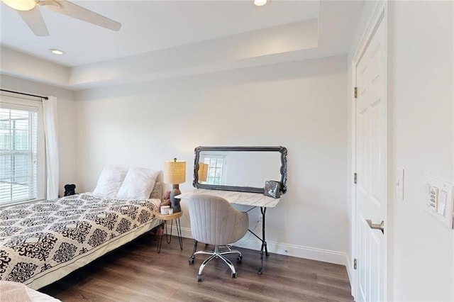 3275 Lenox Rd NE Unit 413, Atlanta, GA 30324 - bedroom featuring wood finished floors, a tray ceiling, recessed lighting, and ceiling fan