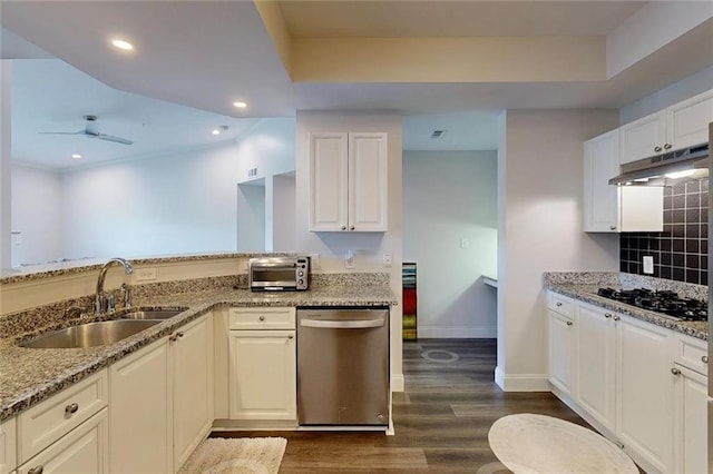 3275 Lenox Rd NE Unit 413, Atlanta, GA 30324 - kitchen with dishwasher, under cabinet range hood, black gas stovetop, light stone counters, and dark wood-style flooring