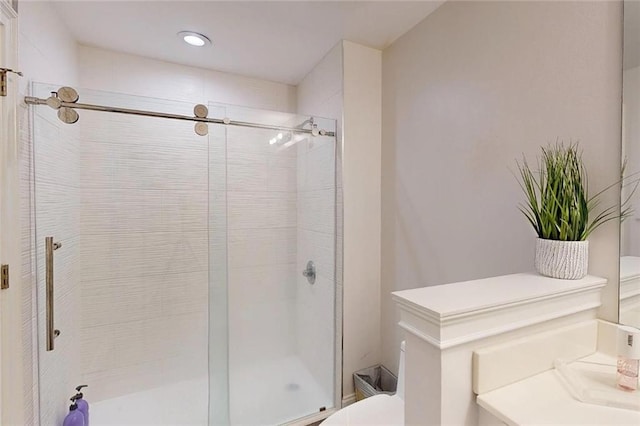 3275 Lenox Rd NE Unit 413, Atlanta, GA 30324 - bathroom with a shower stall, vanity, and recessed lighting
