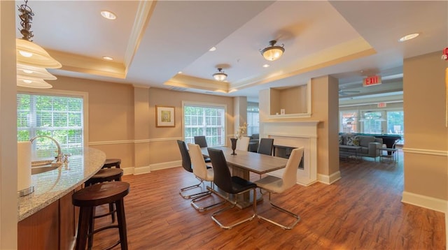 3275 Lenox Rd NE Unit 413, Atlanta, GA 30324 - dining room with a tray ceiling, healthy amount of natural light, wood finished floors, ornamental molding, and recessed lighting