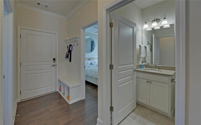 5638 Maple Bluff Way, Hoschton, GA 30548 - interior space with vanity, wood finished floors, visible vents, ensuite bath, and crown molding