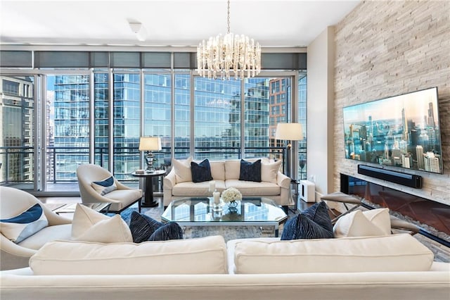 living area featuring an inviting chandelier, a fireplace, and expansive windows