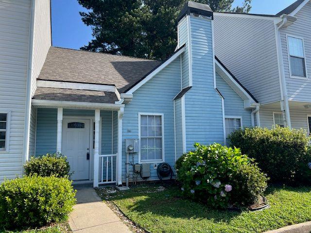 5961 Sherwood Trce, Stonecrest, GA 30038 - property entrance with roof with shingles and a chimney