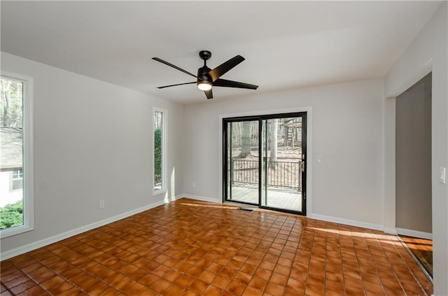 spare room featuring plenty of natural light and baseboards