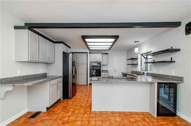 kitchen with open shelves, a sink, beverage cooler, a peninsula, and stainless steel fridge with ice dispenser